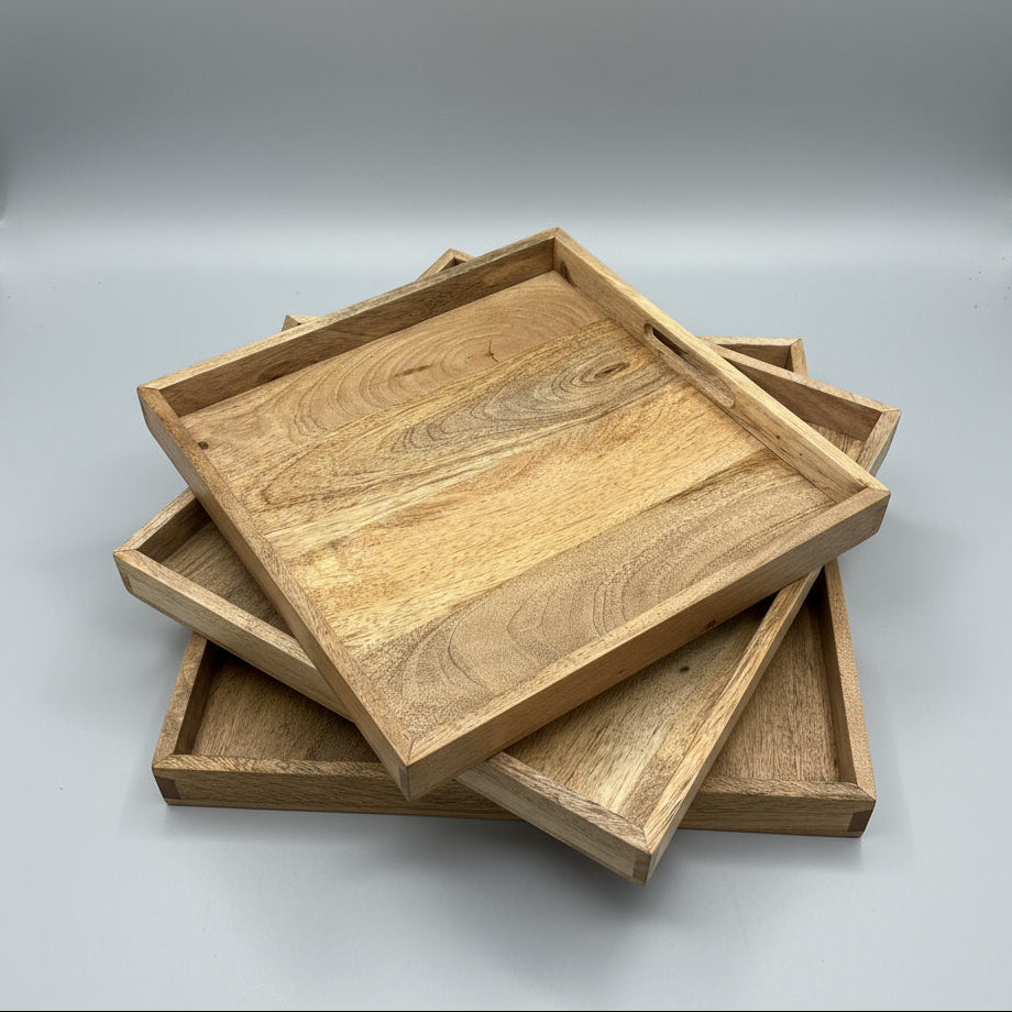 Stack of wooden trays on a gray surface