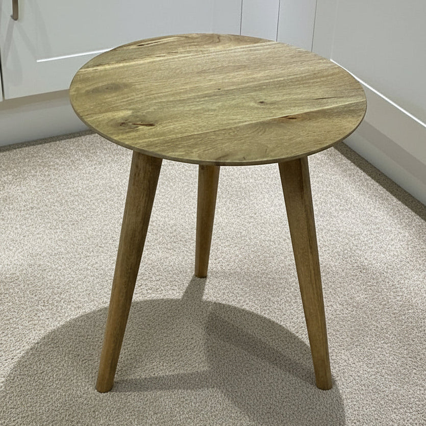 Wooden side table on a tiled floor with white cabinets in the background