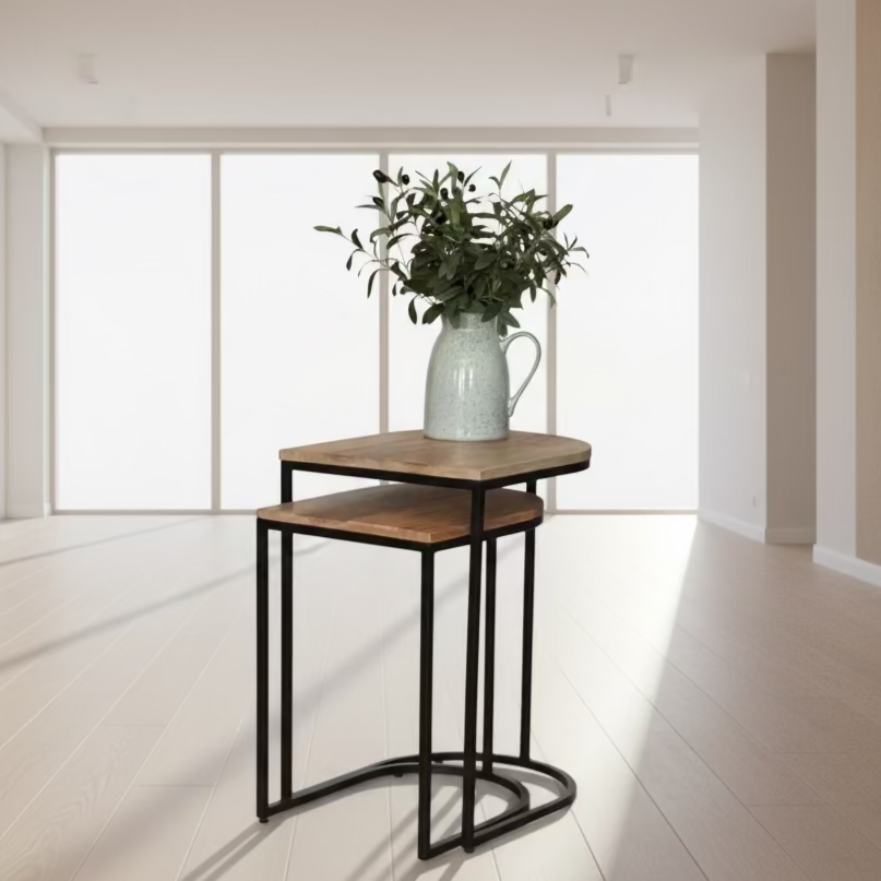 Nesting tables with a vase of greenery in a living room setting.