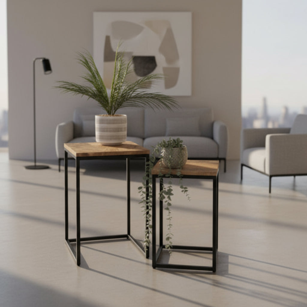 Two small wooden tables with plants on a light wood floor against a gray wall.