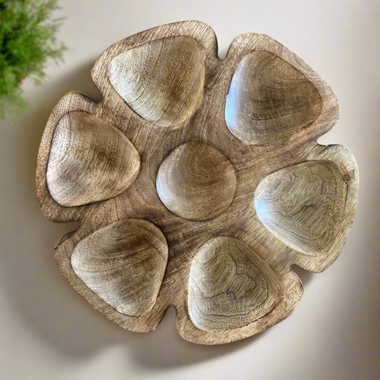Wooden bowl with multiple compartments on a wooden surface