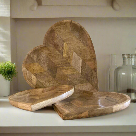 Set of wooden trays with geometric patterns on a neutral background