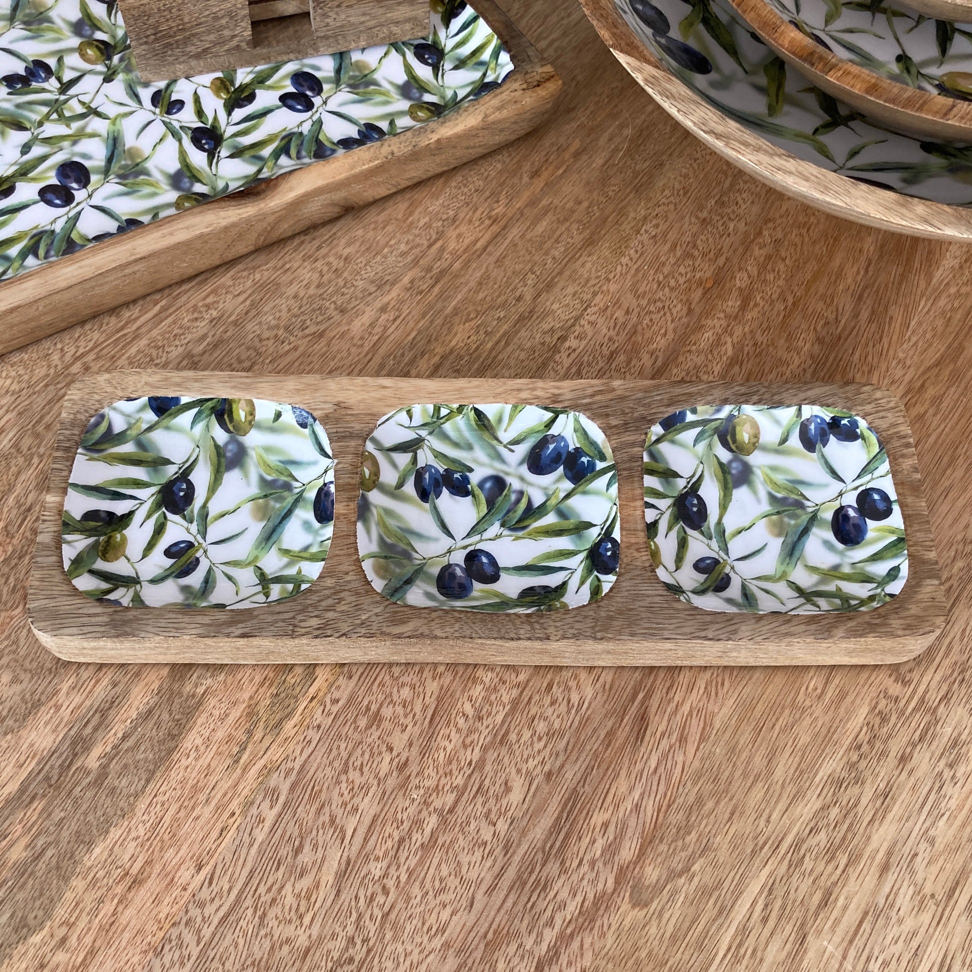 nibbles dish with olive design on a wooden tray