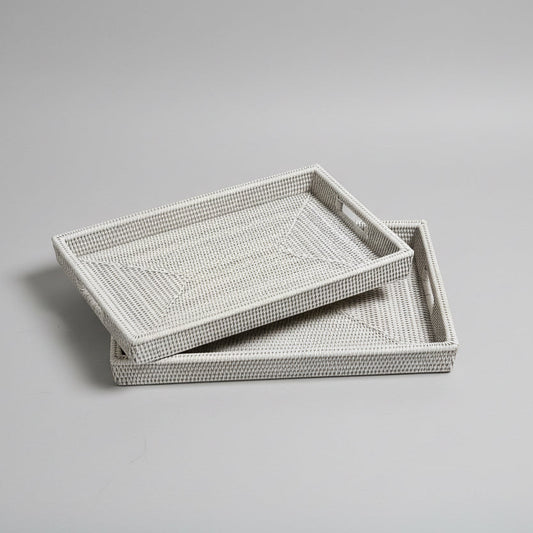 Two woven trays on a concrete floor