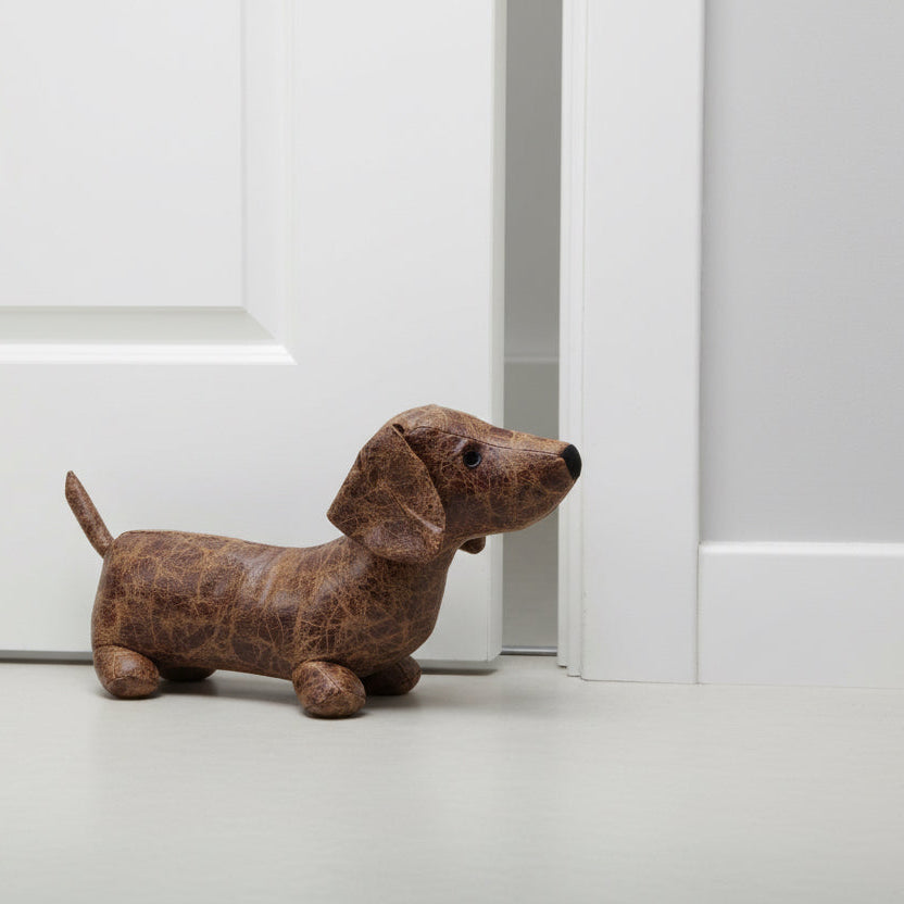 Stuffed dachshund toy on a concrete floor