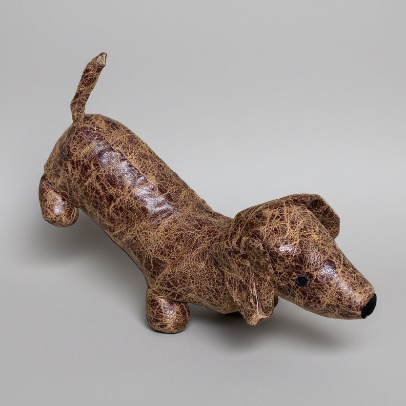 Brown dog-shaped plush toy on a gray background