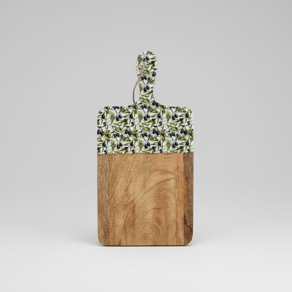 Wooden cutting board with a decorative handle on a wooden floor.