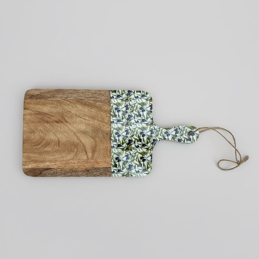 Wooden cutting board with a floral-patterned handle on a wooden surface