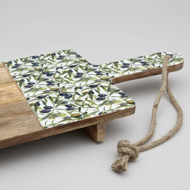 Wooden tray with olive patterned mat and rope on a wooden floor