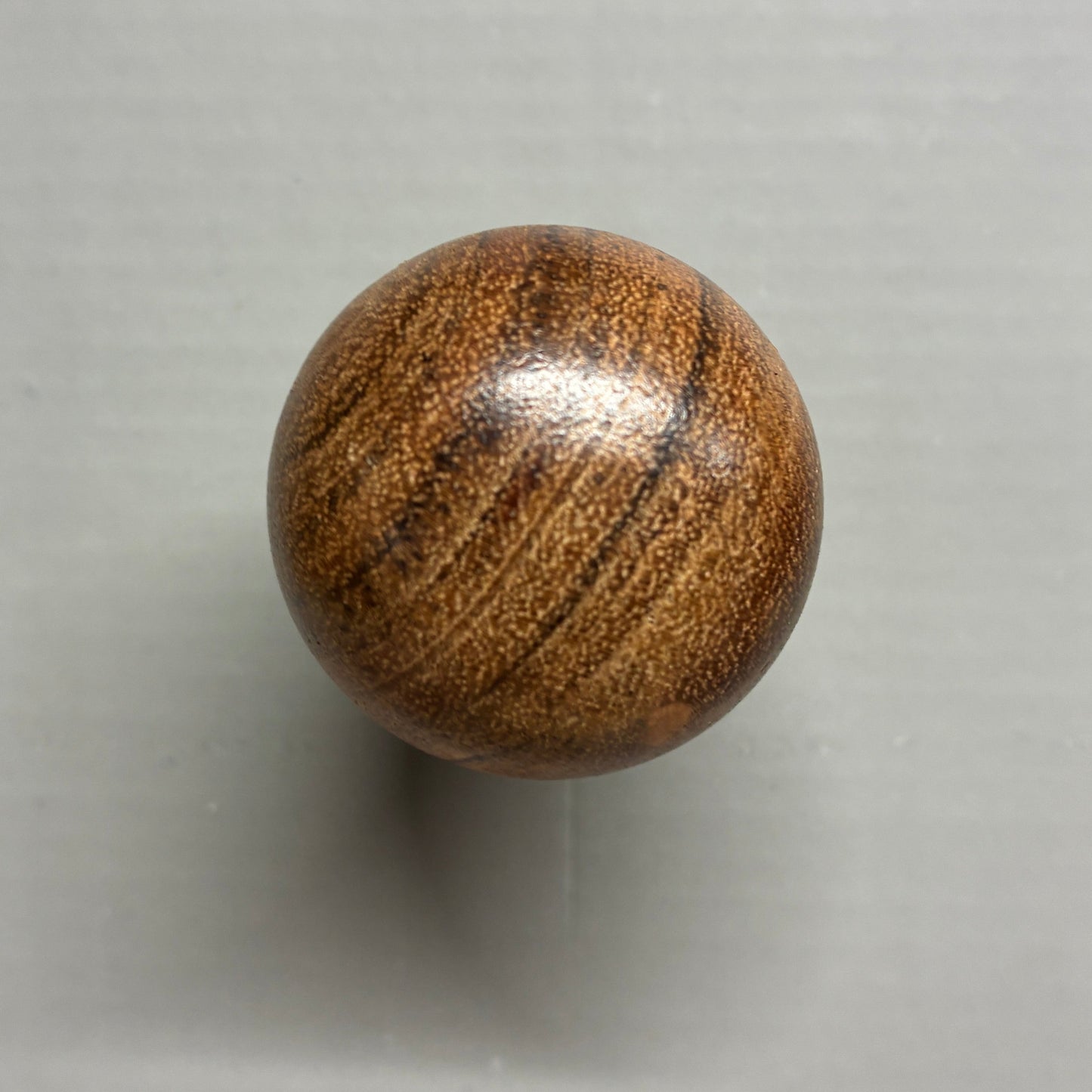 Wooden sphere on a gray background