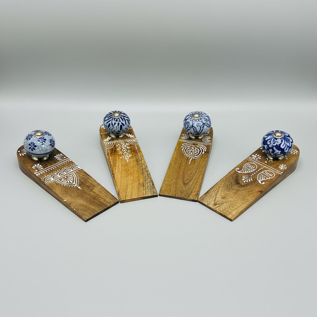 Wooden doorstops with blue floral designs on a black background