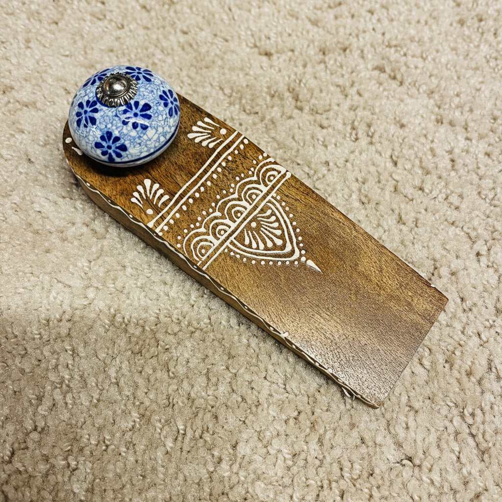 Wooden handle with floral knob on a dark surface