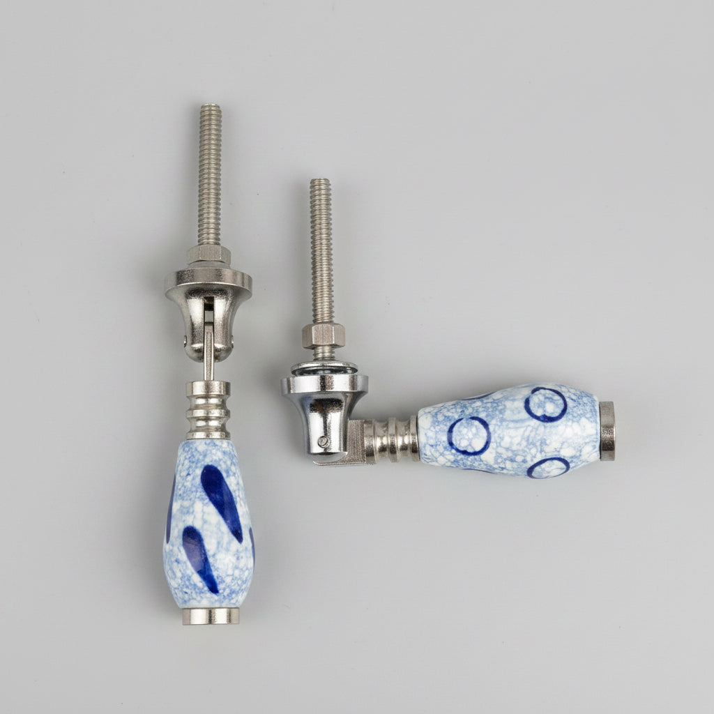 Two ceramic knobs with blue patterns on a gray background