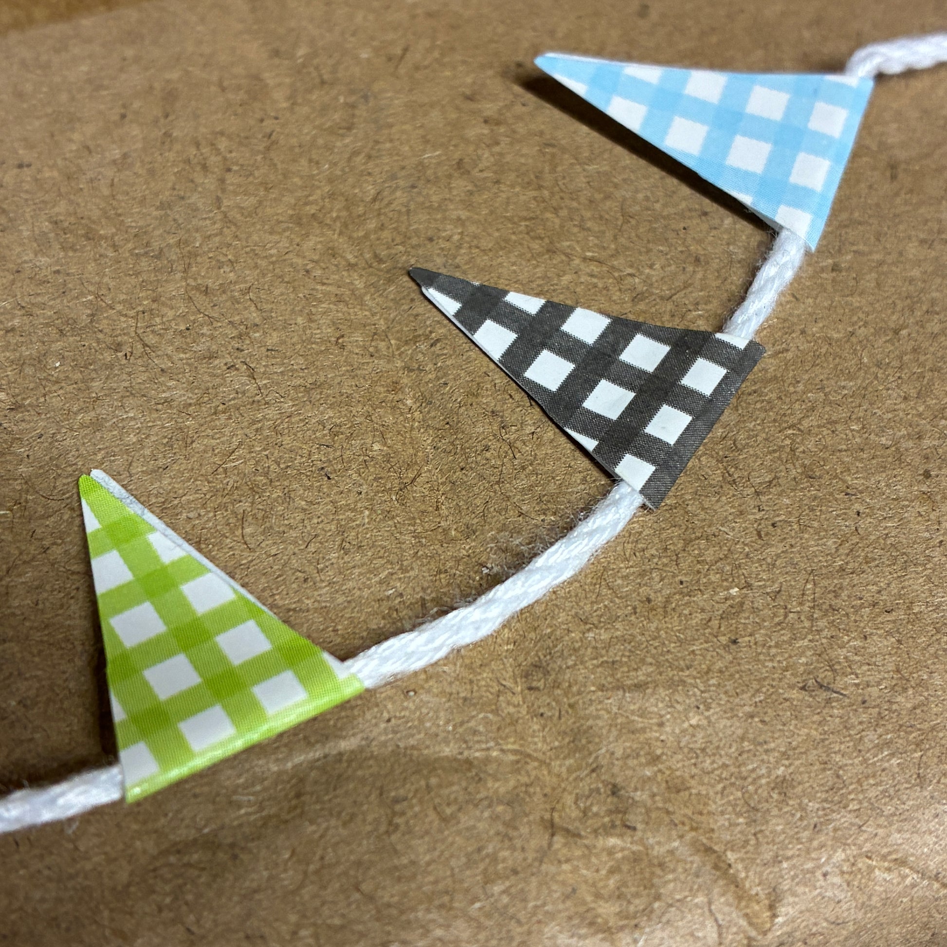 Triangle-shaped flags with different patterns on a brown surface