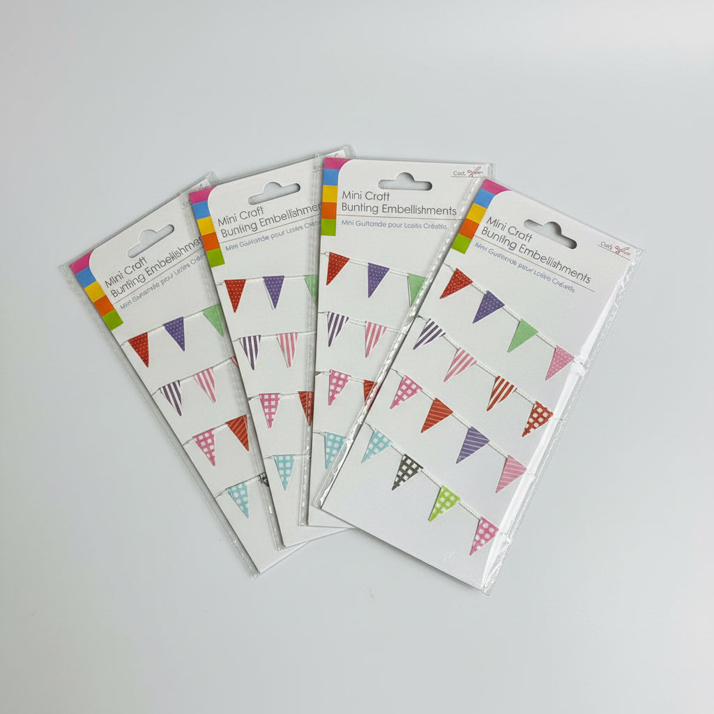 Four packages of Mini Craft Bunting Embellishments on a dark surface