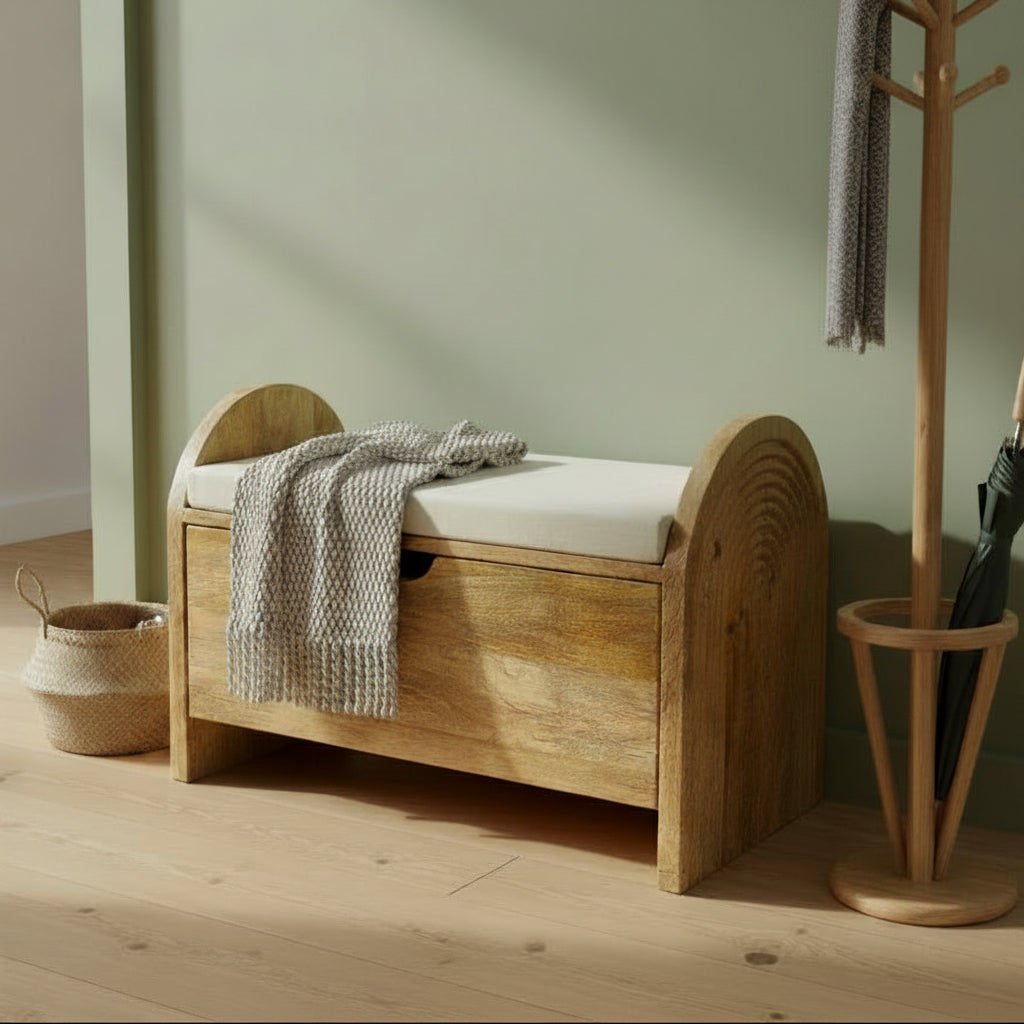 A rustic wooden storage bench with a single drawer and a white cushioned seat, photographed in a workshop or furniture showroom setting.