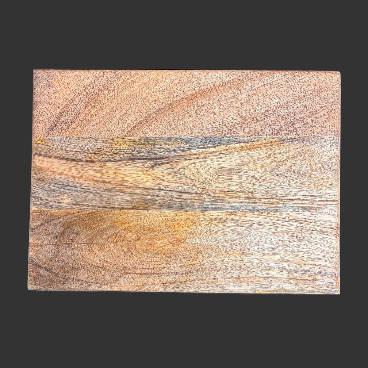 A rectangular wooden board or tile with a natural wood grain pattern in warm brown, beige, and tan tones, shown against a solid dark gray background.