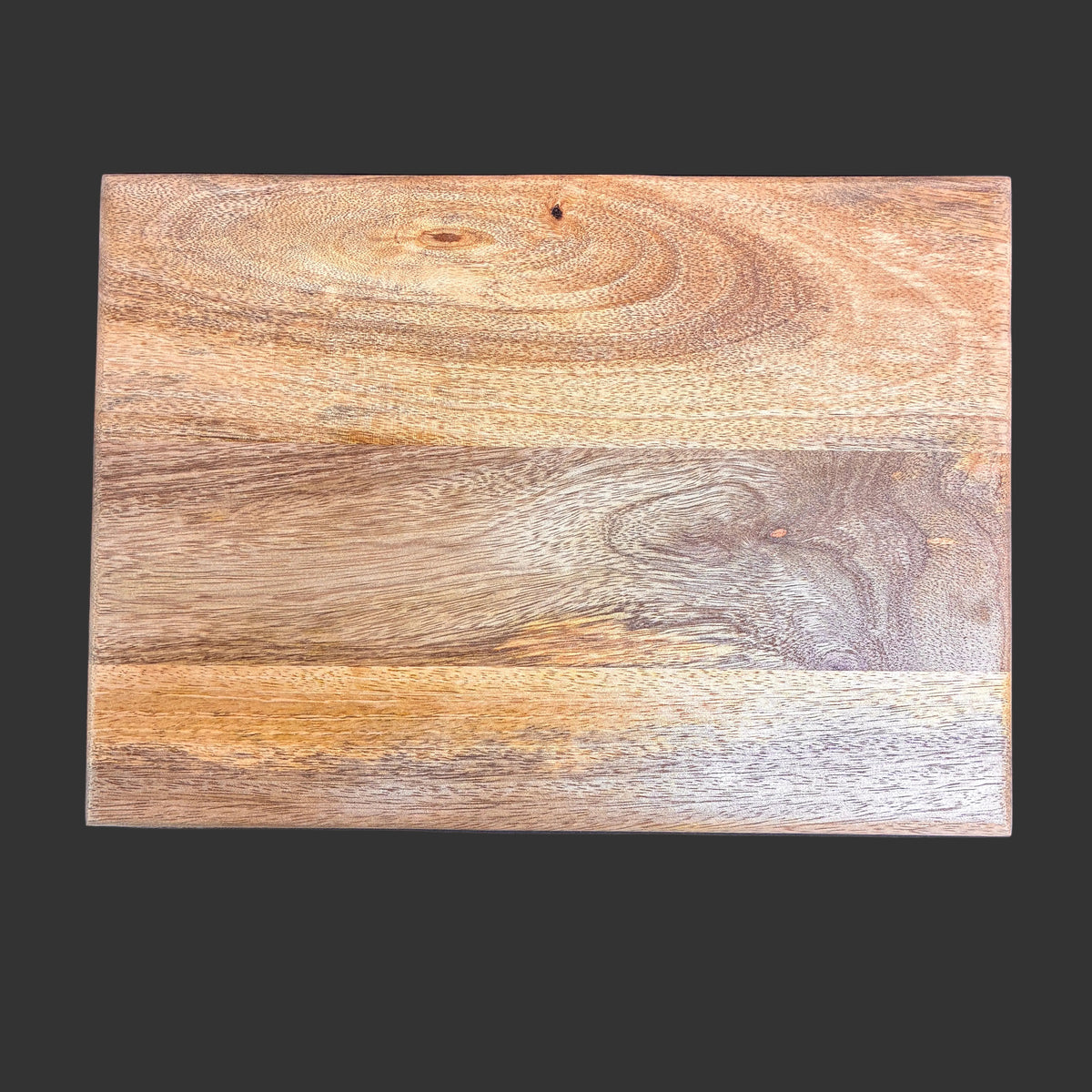 A rectangular wooden board with a natural wood grain pattern, featuring warm brown, tan, and beige tones, shown against a solid dark gray background.