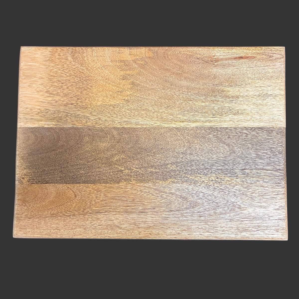 A rectangular wooden board with a natural wood grain pattern, featuring a prominent horizontal band of darker brown wood in the center, set against a dark gray background.
