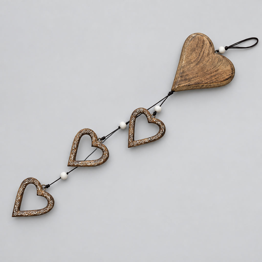 A rustic wooden heart-shaped hanging decoration with three smaller hearts connected by a string to a larger heart at the end, displayed on a white surface.