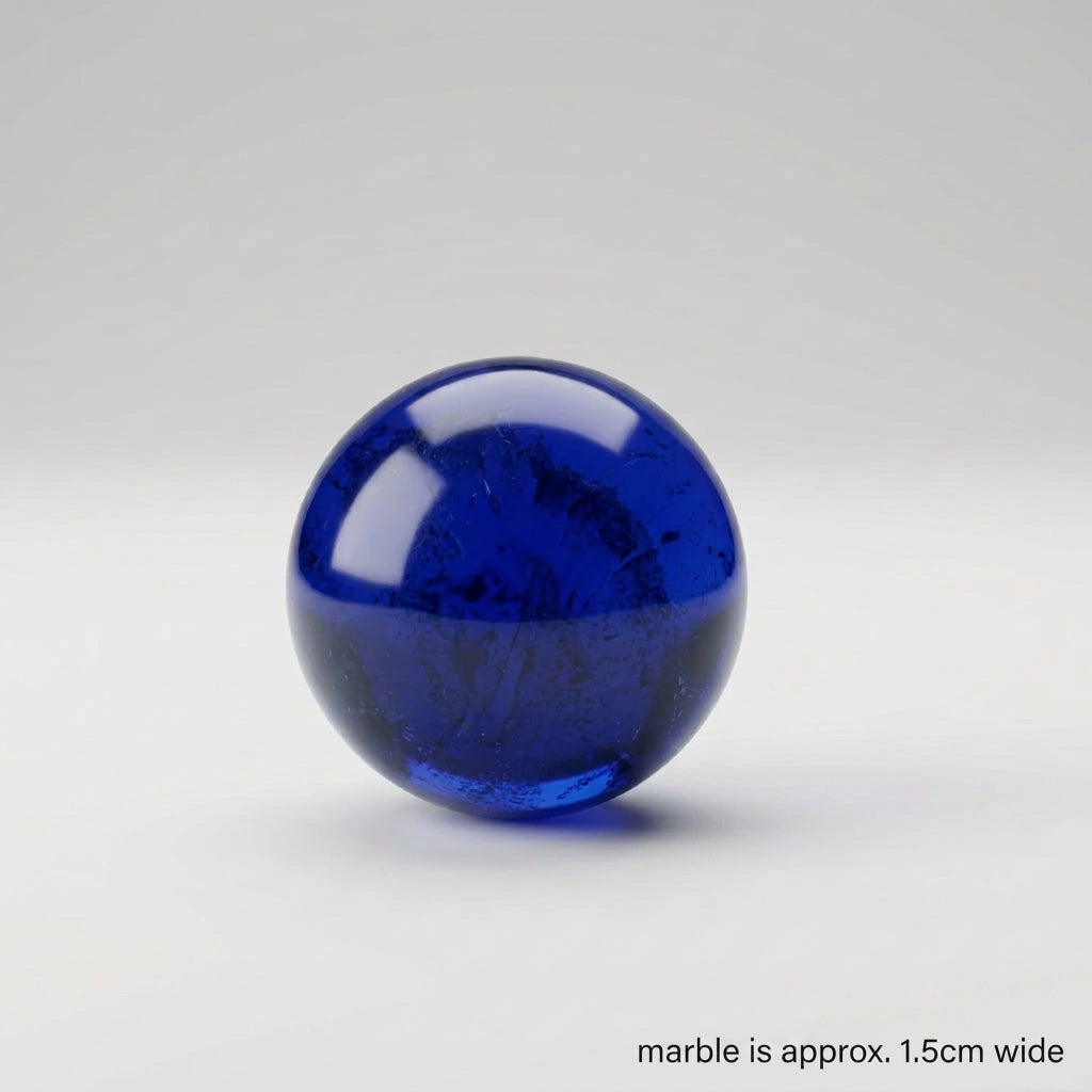 A glossy cobalt blue glass sphere with subtle internal texture, centered on a light gray studio background.