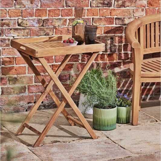 Butler tray in garden with a bench