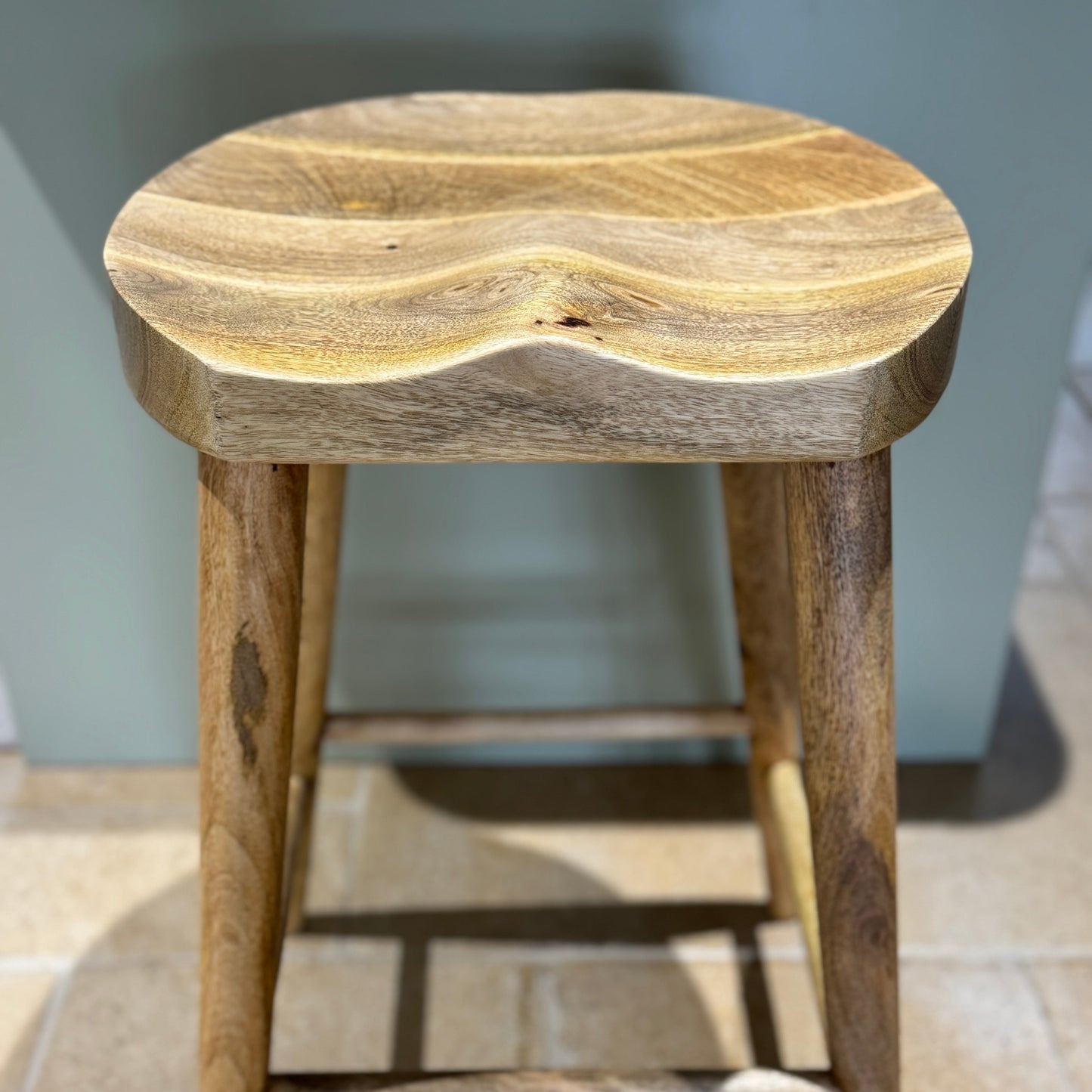 Mango wood bar stool with scalloped seat looking from the front