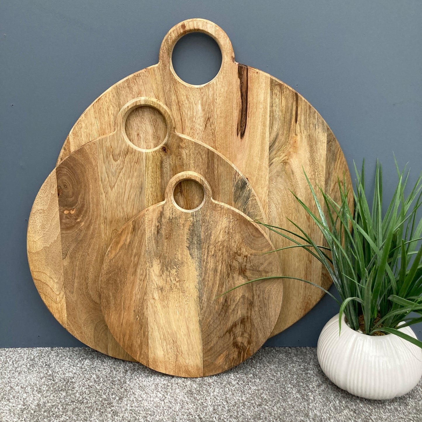 Round loop handled food boards made from solid Mango wood. As a set of three