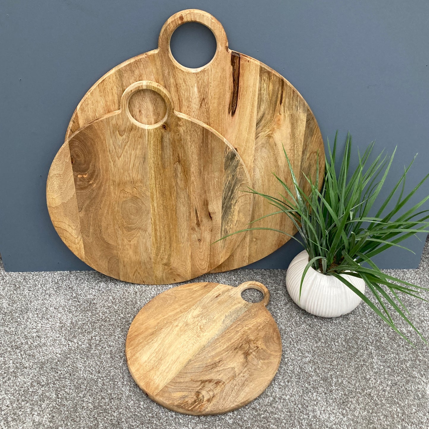 Round loop handled food boards made from solid Mango wood. with more detail