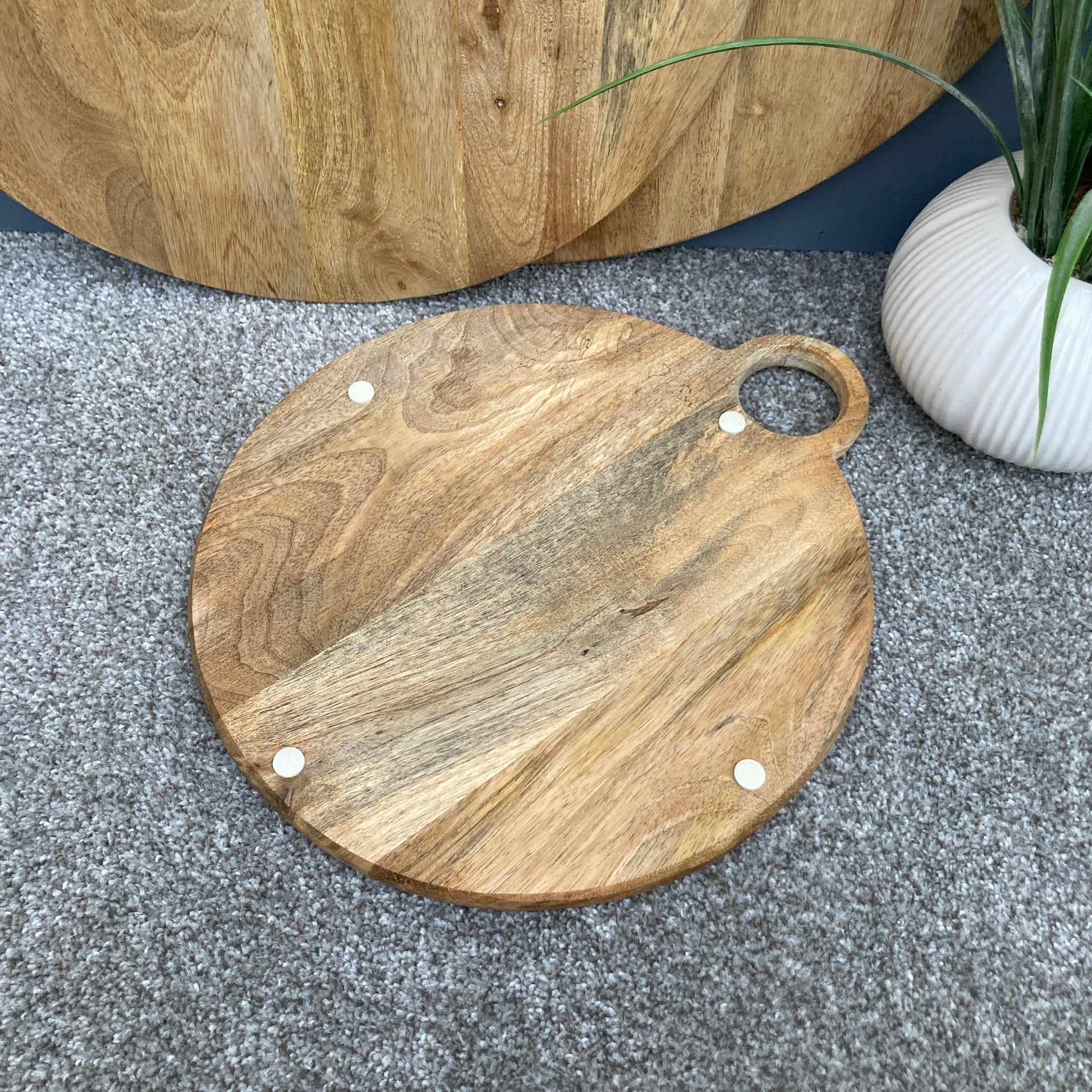 Round loop handled food boards made from solid Mango wood. underside