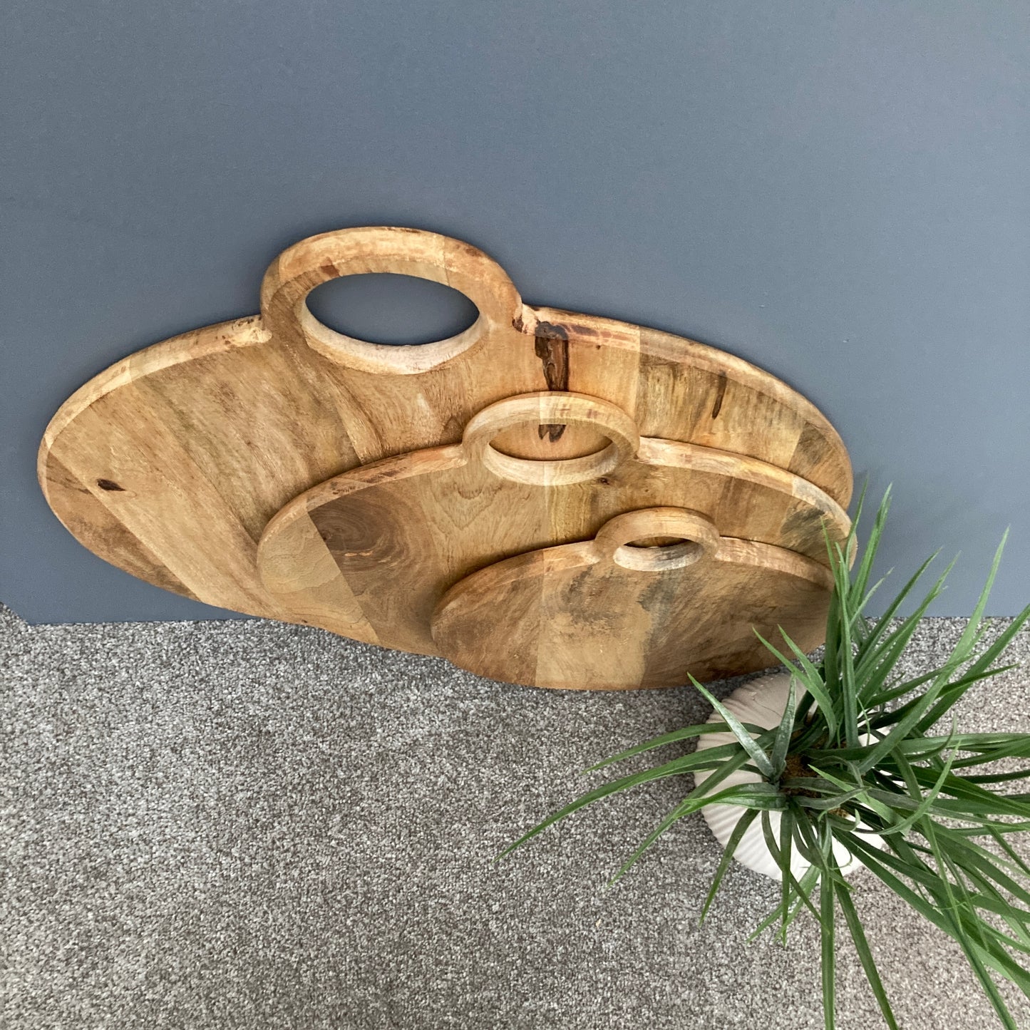 Round loop handled food boards made from solid Mango wood. In more detail from above