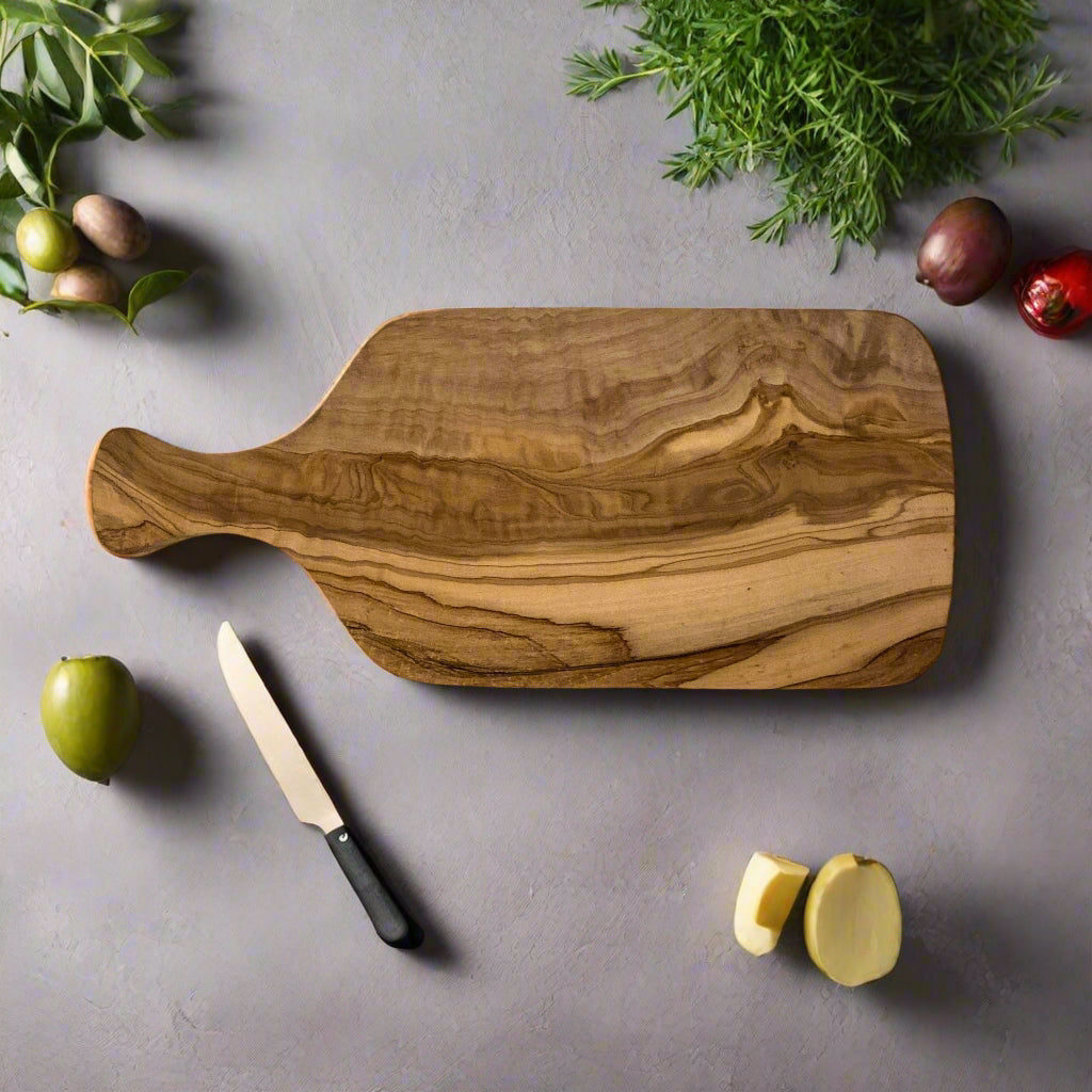 Olive wood paddle shaped chopping board landscape. 