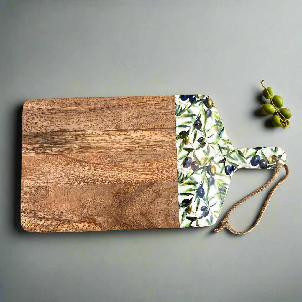 Olive grove design enamelled Mango wood food serving paddle board on a worktop