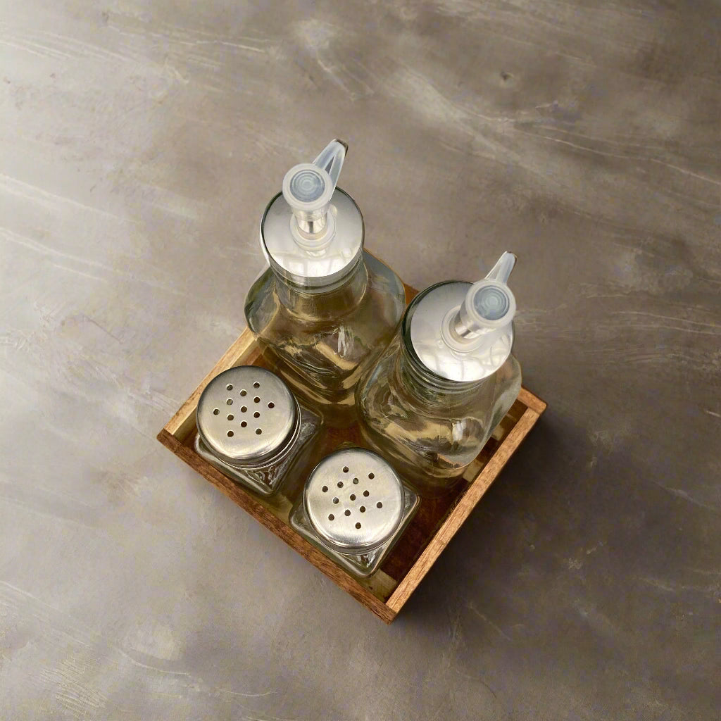 Acacia wood condiment tray. Salt & pepper shakers, oil & vinegar bottles included. Shot from above.