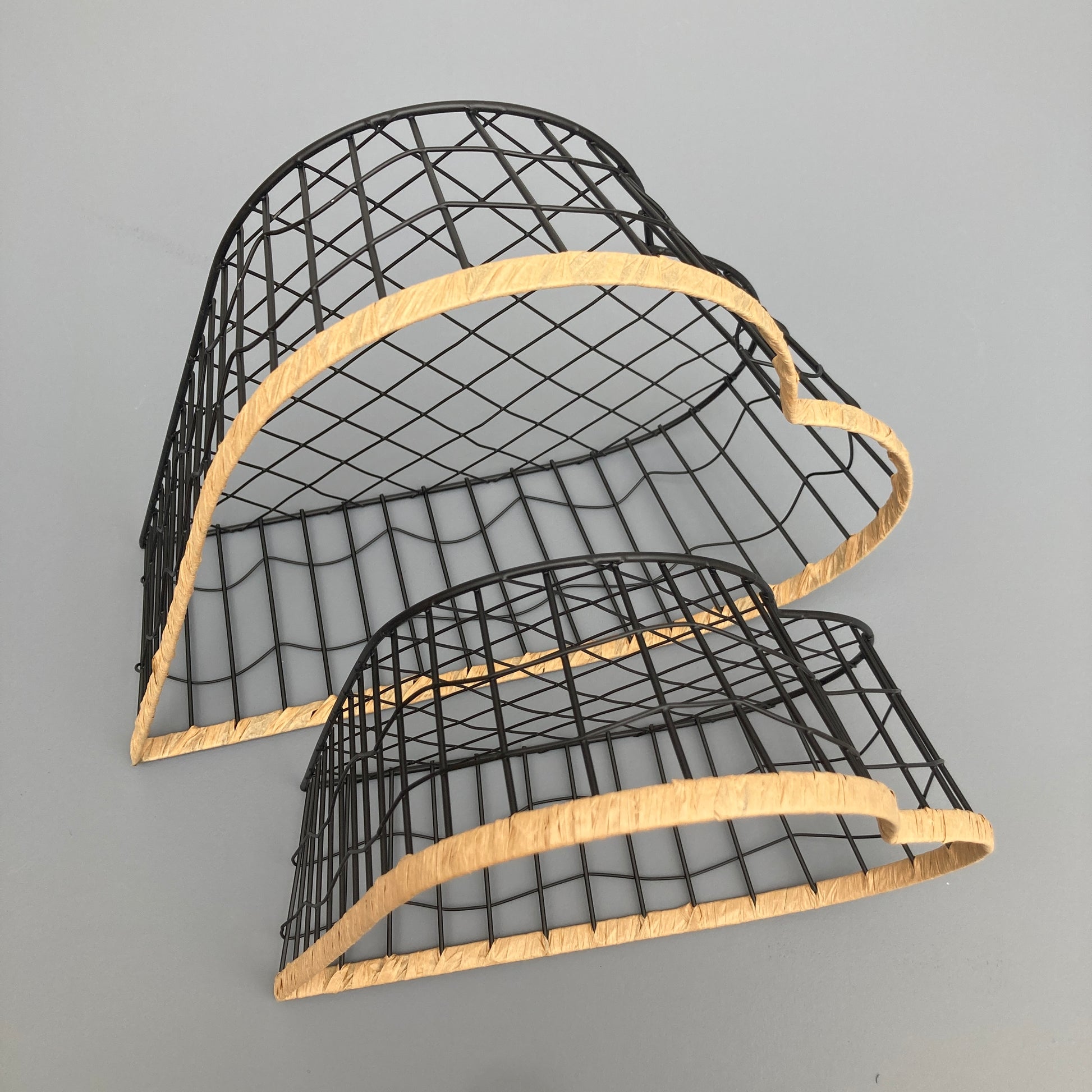 Heart shaped woven metal fruit baskets with raffia edging. View from above.