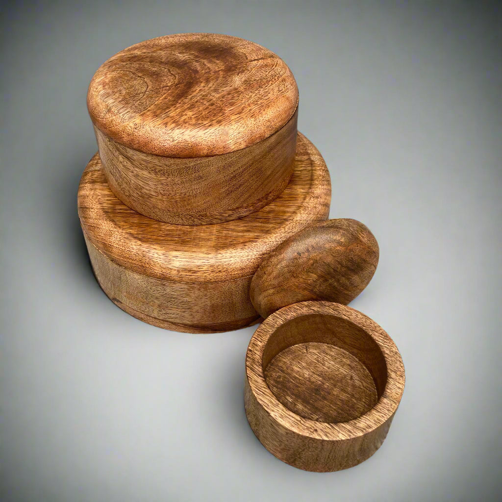 Dark Mango wood round lidded boxes. Small box open.