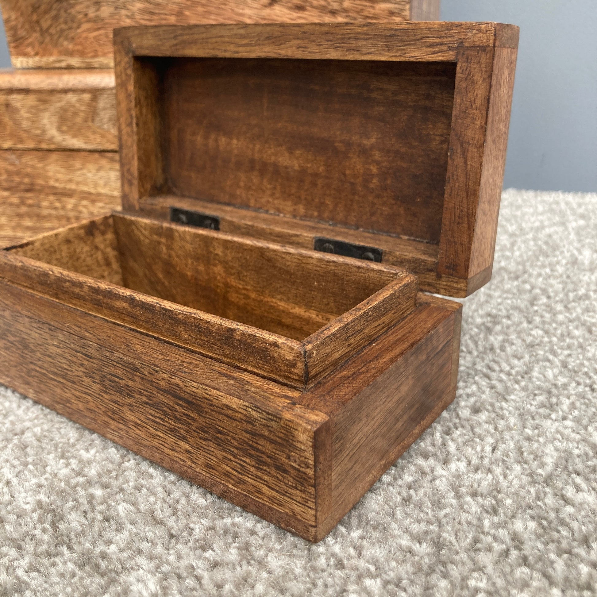 Dark Mango wood rectangular lidded boxes. Close up of open small box. 
