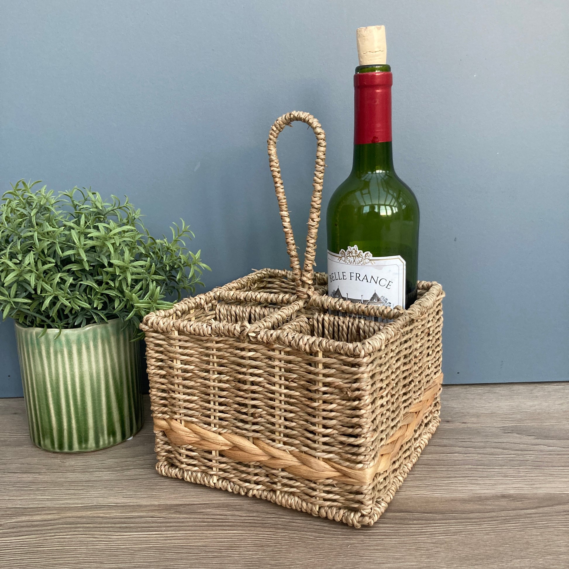 Woven seagrass and water hyacinth condiment caddy with wine bottle