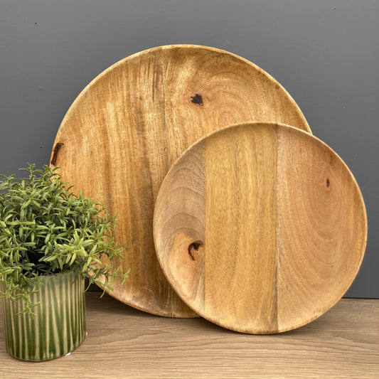Solid Mango plate in 2 sizes standing up on a counter