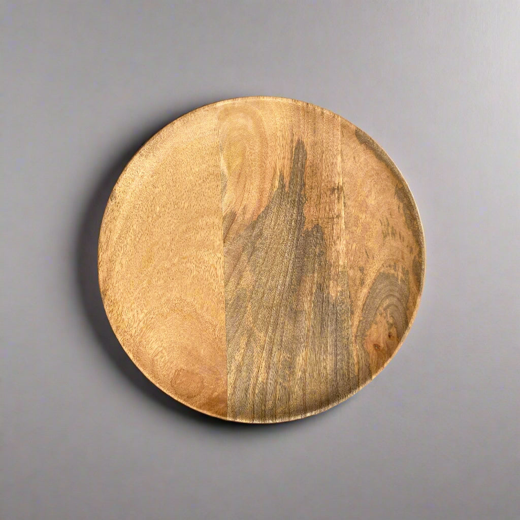 Solid Mango plate from above on a grey background
