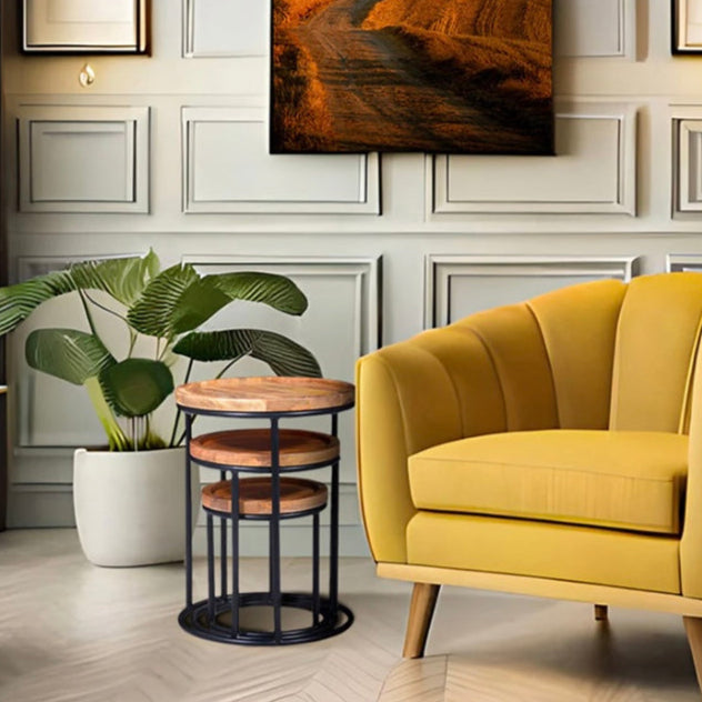 Industrial nest of 3 tables by a yellow chair