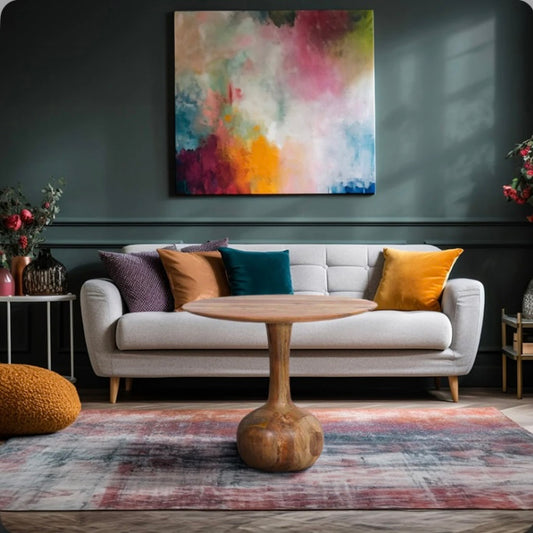 Solid Mango Wood Round Table with Pedestal front of a sofa 