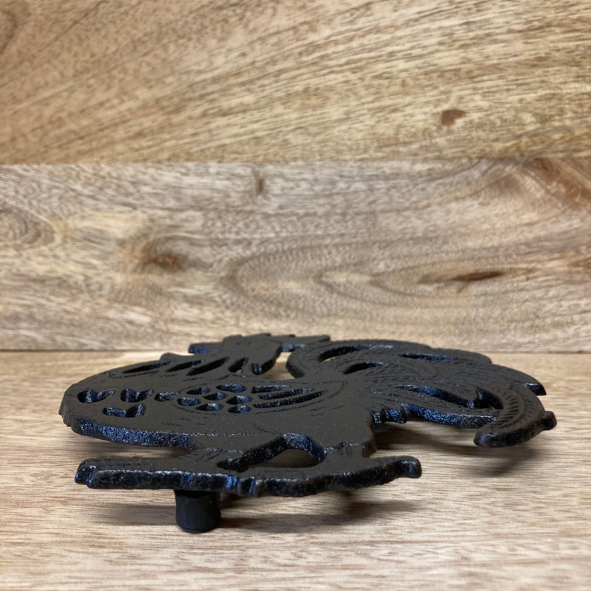 Black painted cast iron ROOSTER design trivet / hotplate - at an angle