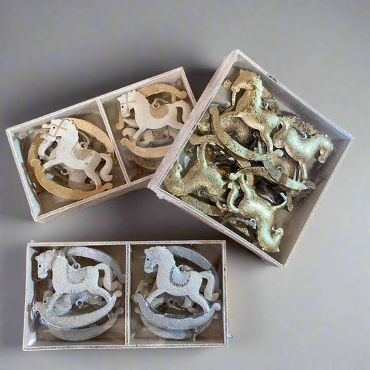 Hanging rocking horses in box.