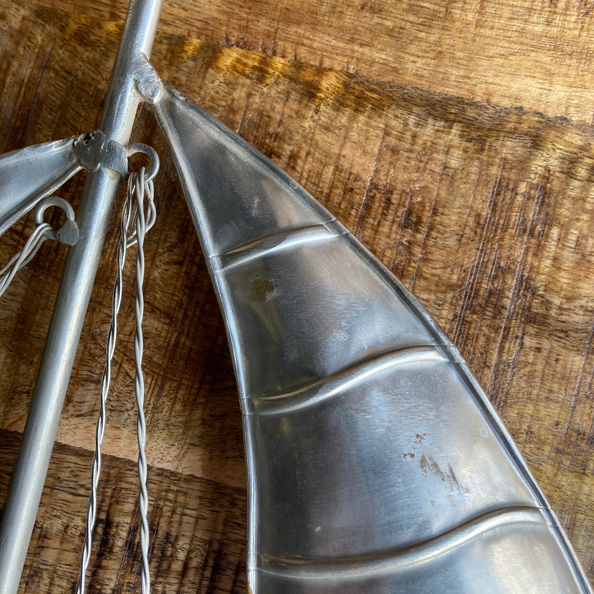 Large reclaimed rustic wood yachts with metal sail- close up of sail