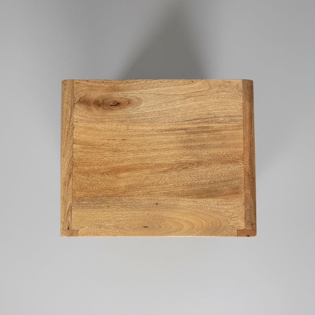 Wooden box with a visible grain pattern on a dark surface