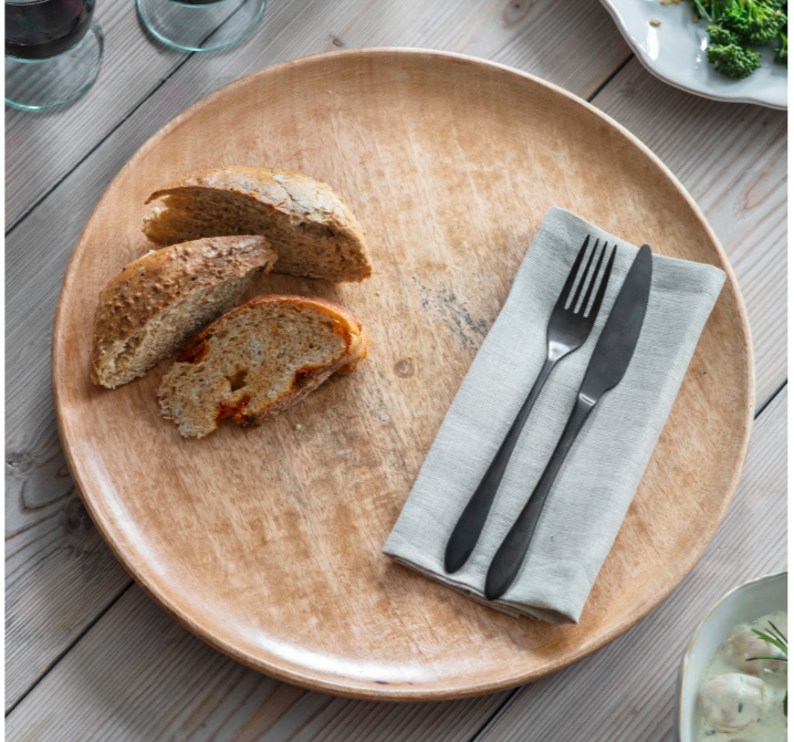 Solid Mango plate in 2 sizes being used as a charger