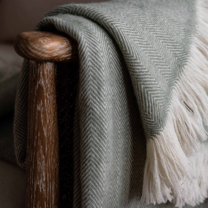 Herringbone wool throw 170x130cm- Sage. Close up shot. 