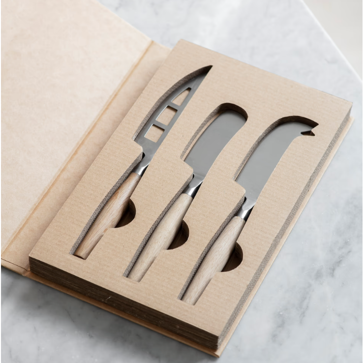 Set of knives in a cardboard packaging on a marble surface