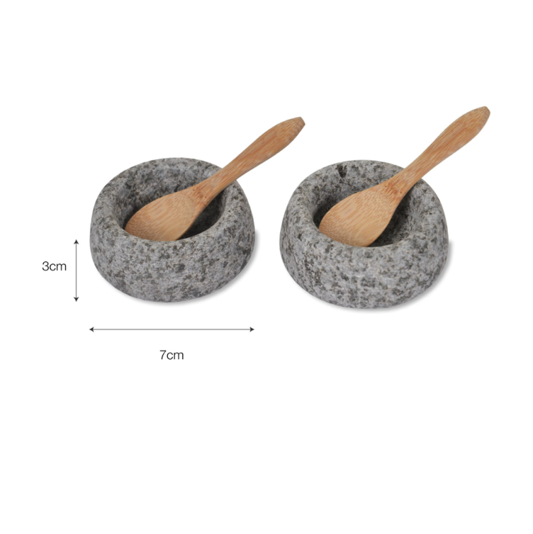 Two small stone bowls with wooden spoons on a white background